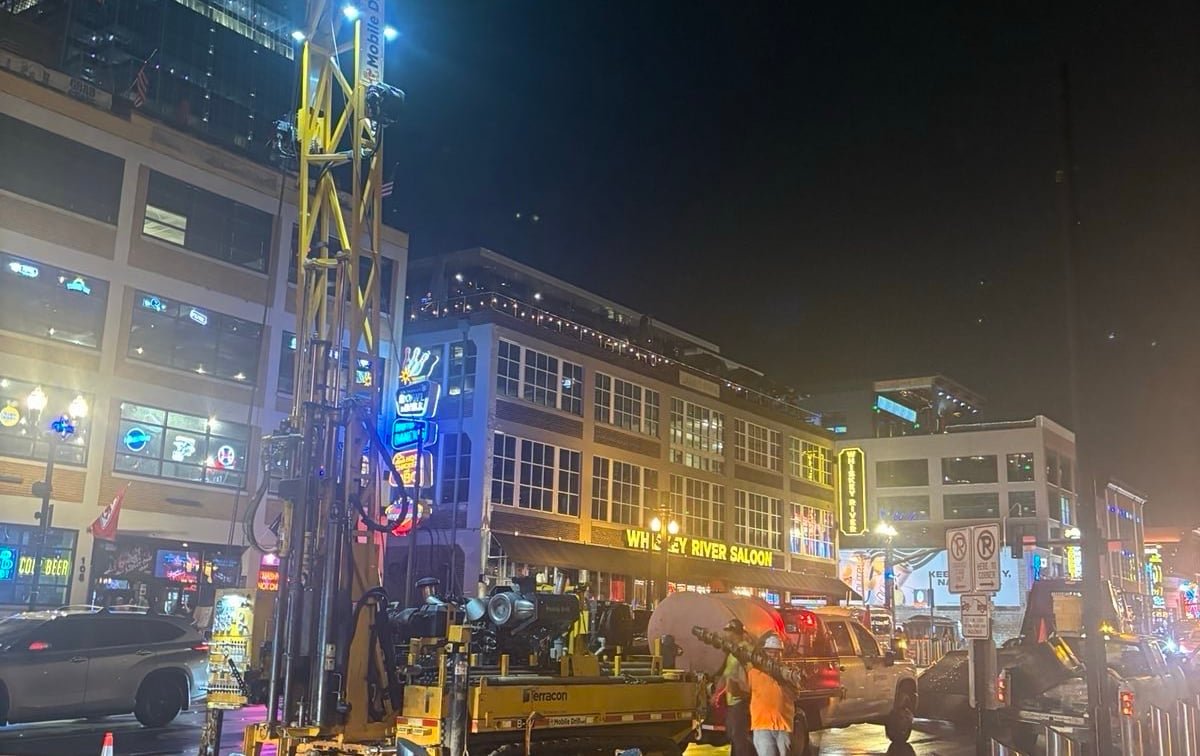 Geotechnical drilling equipment operating on Lower Broadway in downtown Nashville.